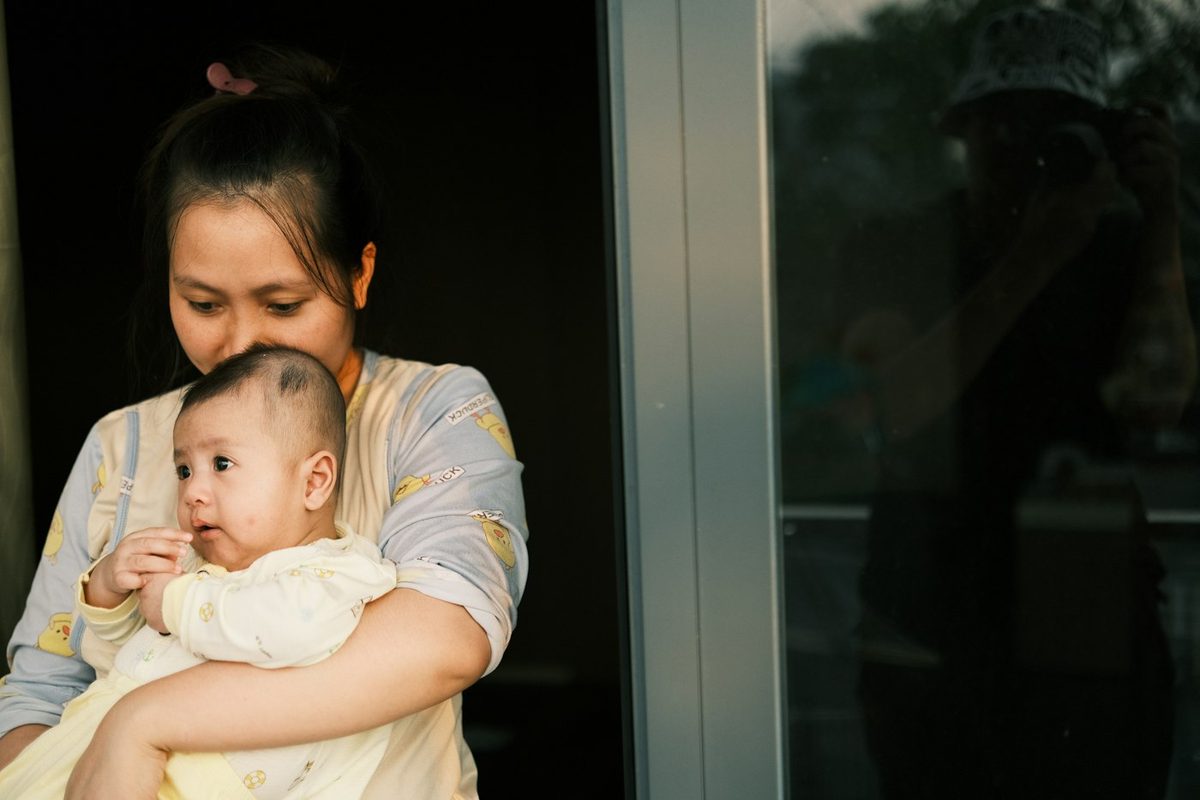 A caregiver holding a child safely at home
